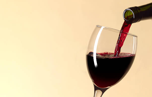 pouring glass of red wine with copy space - drink wine stock pictures, royalty-free photos & images