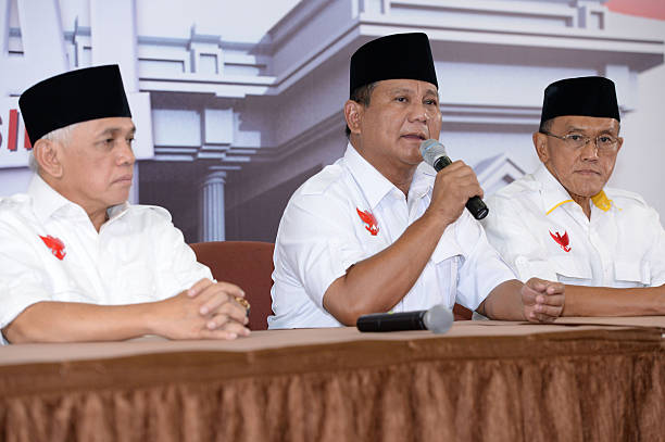Prabowo Subianto presidential candidate center speaks during a news conference after a debate against opponent Joko Widodo in Jakarta Indonesia on...