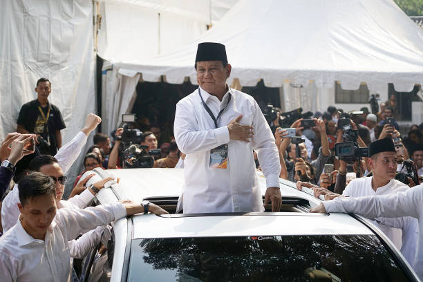 Prabowo Subianto presidential candidate greets supporters after submitting his nomination papers to the General Election Commission in Jakarta...