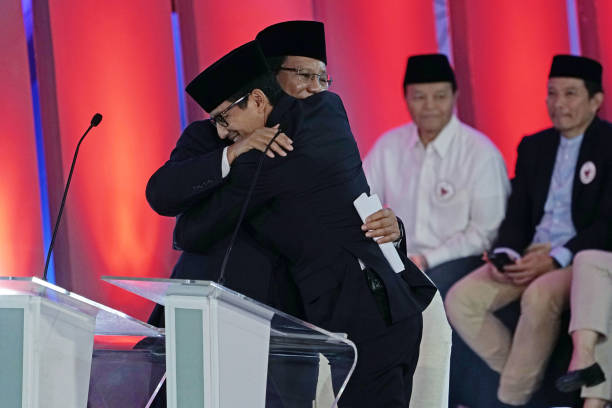 Prabowo Subianto presidential candidate left hugs Sandiaga Uno vice presidential candidate listens following a first presidential debate in Jakarta...