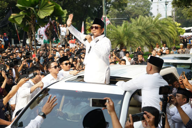 Prabowo Subianto presidential candidate waves while speaking to supporters after submitting his nomination papers to the General Election Commission...