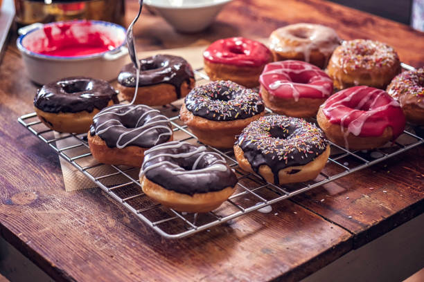 preparing homemade donuts - donuts stock pictures, royalty-free photos & images