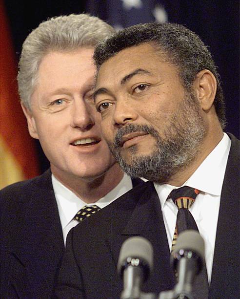 President Bill Clinton stands behind Ghana's President Jerry John Rawlings at the end of their joint press conference at the White House 24 February...