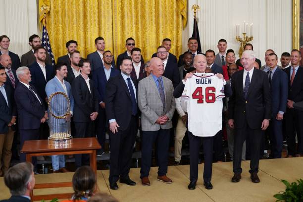 President Joe Biden holds a jersey presented to him during an event in honor of the 2021 World Series champions the Atlanta Braves in the East Room...