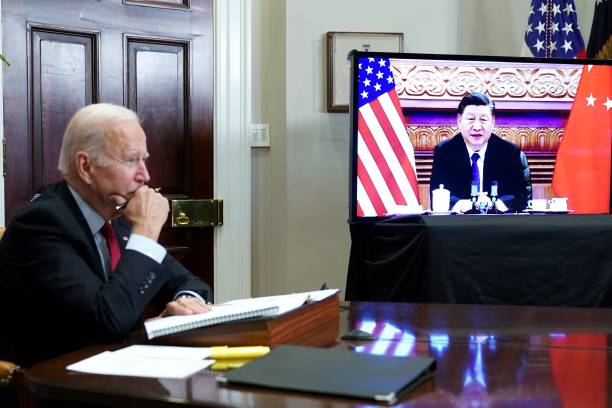 President Joe Biden meets with China's President Xi Jinping during a virtual summit from the Roosevelt Room of the White House in Washington, DC,...