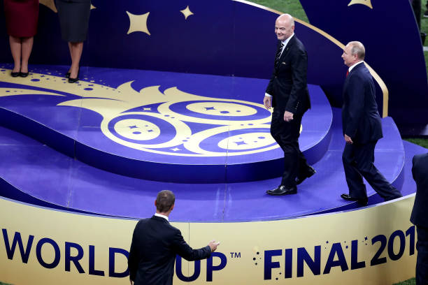 President of Russia Vladimir Putin and FIFA president Gianni Infantino walk onto the podium prior to the trophy presentation following the 2018 FIFA...