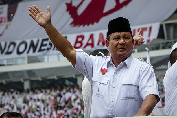 Presidential candidate retired general Prabowo Subianto the leader of the Gerindra party greets supporters during an election rally at Gelora Bung...