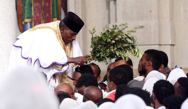 Priest Haileyesus Amare blesses Ethiopian Orthodox Christians with olive branches during the commemoration ceremony of Good Friday ahead of Easter at...