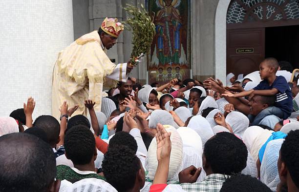 Priest Mesele Gebre conducts a blessing service as Orthodox Christians gather at the Medhane Alem Cathedral to observe Good Friday ahead of the...