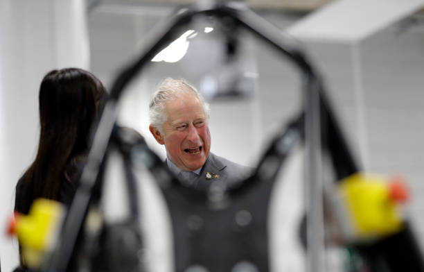 Prince Charles Prince of Wales is seen through a future vehicle as he is shown the engineering hall during a visit to officially open the National...