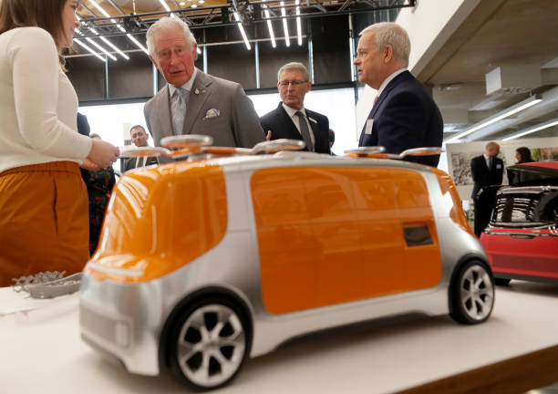 Prince Charles Prince of Wales looks at models of 'Project Vector' during a visit to officially open the National Automotive Innovation Centre and...