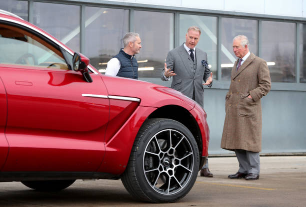 Prince Charles Prince of Wales with Marek Reichman Executive Vice President and Chief Creative Officer of Aston Martin with Aston Martin's first SUV...