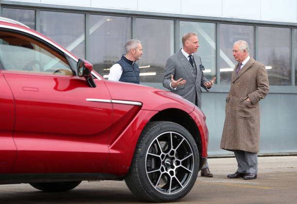 Prince Charles Prince of Wales with Marek Reichman Executive Vice President and Chief Creative Officer of Aston Martin with Aston Martin's first SUV...