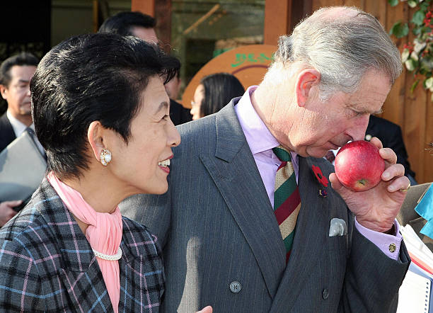 prince-charles-smells-a-local-apple-while-princess-takamado-stands-picture-id83492385