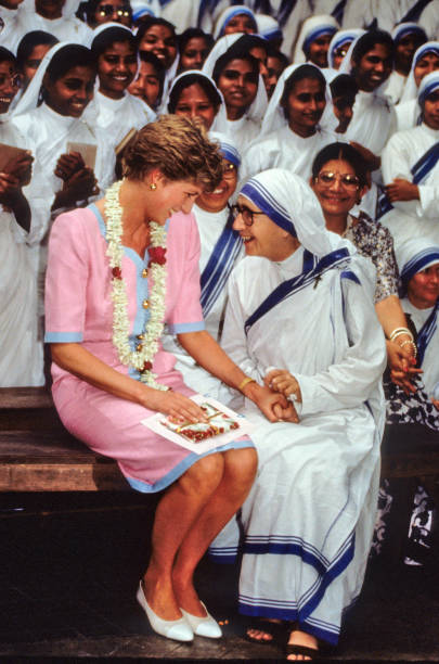 Princess Diana the Princess of Wales holds hands with a nun at Mother Teresa`s Hospice in Calcutta during her visit to India in February of 1992.