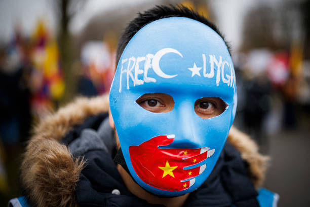 Protester holds a placard reading 'Shame on China' during a protest march gathering Tibetans from the International Olympic Committee headquarters to...