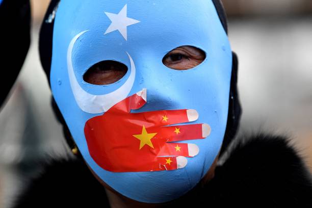 Protester wearing a face mask attends a demonstration in Sydney on June 23, 2021 to call on the Australian government to boycott the 2022 Beijing...