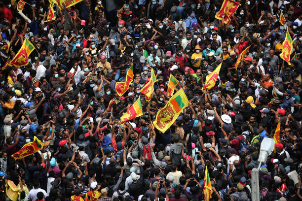 Protesters gather in a street leading to the presidents official residence, against Sri Lanka's President Gotabaya Rajapaksa while demanding his...