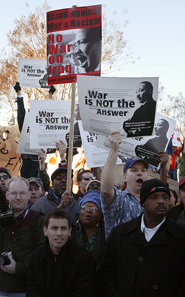 Protesters shout as President George W. Bush placed a wreath at the grave of Dr. Martin Luther King Jr. Several hundred protesters loudly booed Bush...