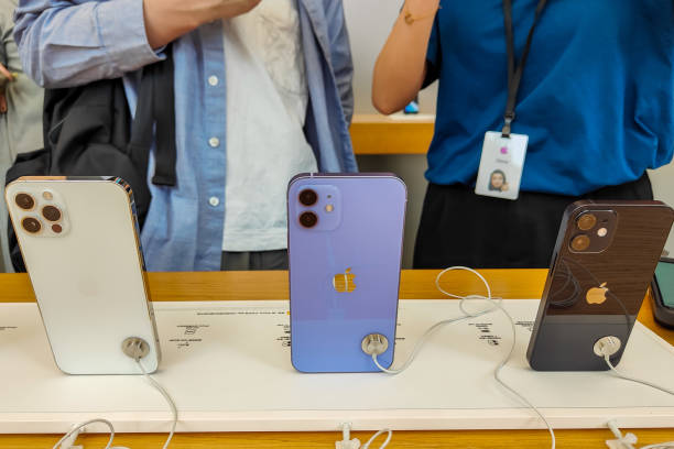 purple iphone 12 smartphone is displayed for sale at an apple store picture
