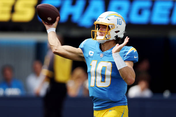 Quarterback Justin Herbert of the Los Angeles Chargers attempts a pass during the first half against the Las Vegas Raiders at SoFi Stadium on...