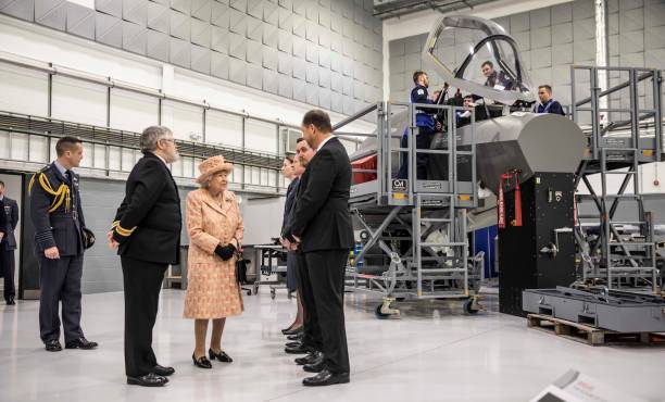 Queen Elizabeth II is escorted by Station commander Group captain James Beck as she meets personnel at RAF Marham where she inspected the new...