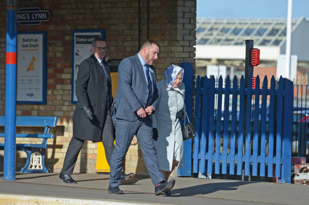 Queen Elizabeth II walks alongside station manager Graeme Pratt as she arrives at King's Lynn railway station in Norfolk ahead of boarding a train as...
