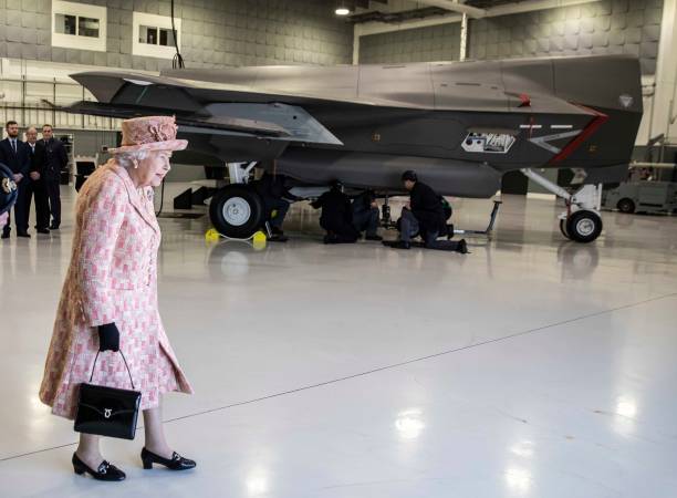 Queen Elizabeth II walks past a training mock up of a F35B Lightning II fighter at RAF Marham where she inspected the new integrated training centre...