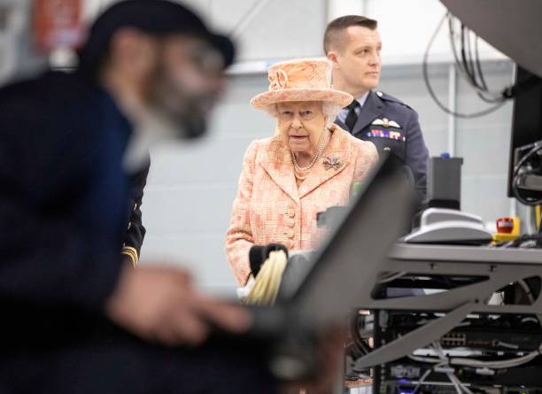 Queen Elizabeth II watches air crew at work on a training model F35B Lightning II fighter as she visits Royal Air Force Marham on February 3 2020 in...