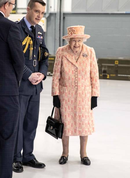 Queen Elizabeth II watches air crew at work on a training model F35B Lightning II fighter at Royal Air Force Marham on February 3 2020 in King's Lynn...