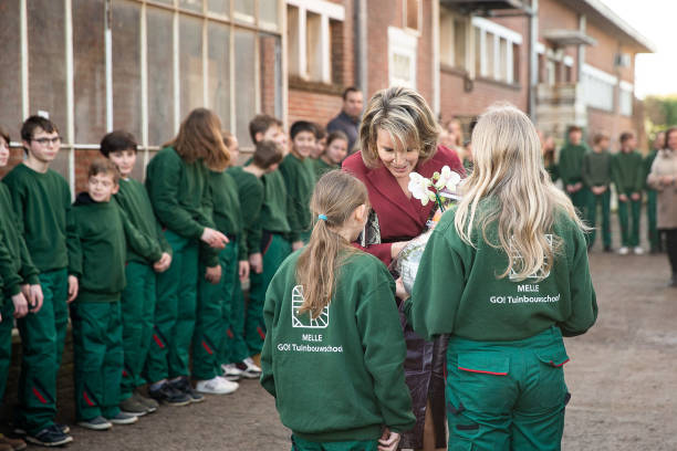 Queen Mathilde of Belgium meets pupils in their green uniforms during a visit of Belgian Queen at the GO Tuinbouwschool part of the week against...