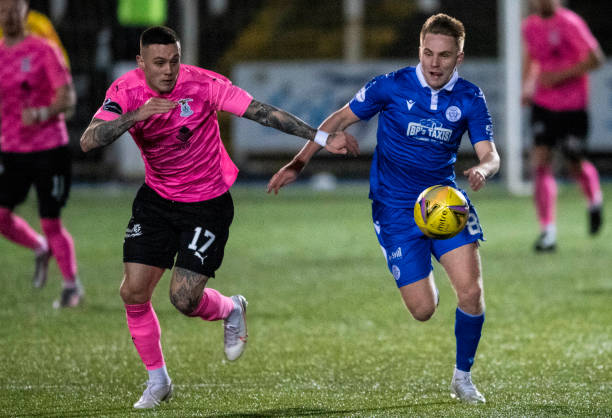 Queen of the South's Danile Pybus competes with Miles Storey during a Scottish Championship match between Queen of the South and Inverness at...
