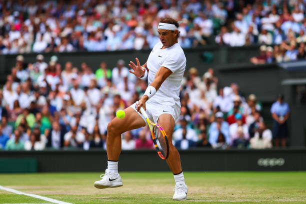 Rafael Nadal of Spain hits a forehand against Taylor Fritz of the United States during day ten of The Championships Wimbledon 2022 at All England...