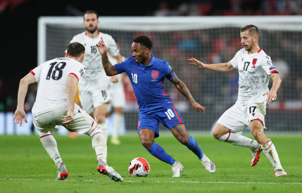 Raheem Sterling of England is challenged by Ardian Ismajli and Ylber Ramadani of Albania during the 2022 FIFA World Cup Qualifier match between...