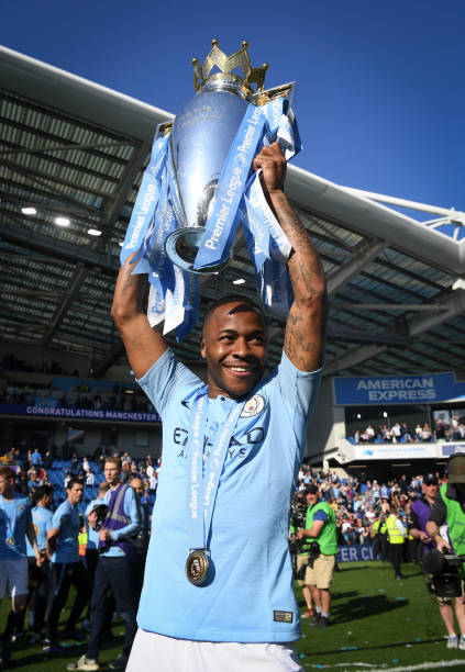 Raheem Sterling of Manchester City poses with the Premier League trophy during the Premier League match between Brighton & Hove Albion and Manchester...