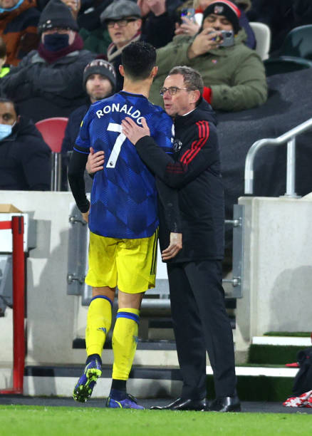 Ralf Rangnick, Manager of Manchester United interacts with Cristiano Ronaldo of Manchester United as he is substituted off during the Premier League...