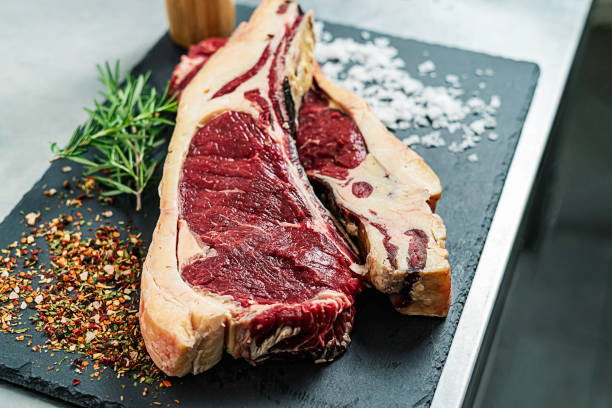 raw steak rosemary and salt on a serving board picture
