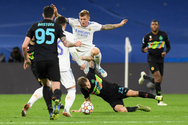 Real Madrid's German midfielder Toni Kroos jumps over Inter Milan's Italian midfielder Nicolo Barella during the UEFA Champions League first round...