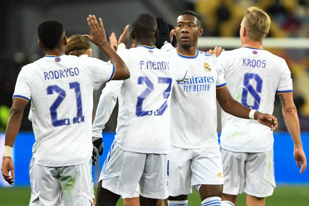 Real Madrid's players celebrate after Shakhtar Donetsk's Ukrainian defender Serhiy Kryvtsov scored an own goal during the UEFA Champions League...