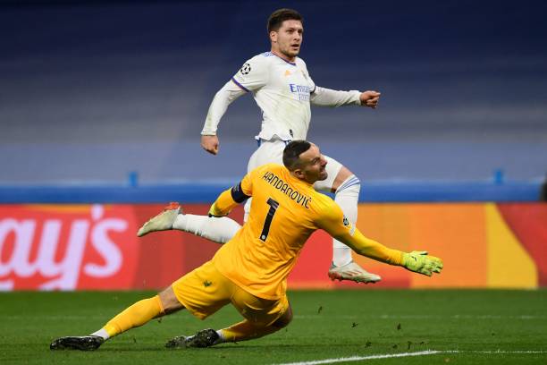 Real Madrid's Serbian forward Luka Jovic runs past Inter Milan's Slovenian goalkeeper Samir Handanovic during the UEFA Champions League first round...