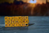Reflect - Rethink - Revise on wooden blocks.