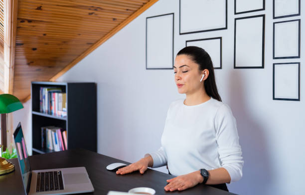 relaxed calm business woman take deep breath of fresh air resting with eyes closed at work in home office. doing office yoga and meditating with closed eyes. - breath stock pictures, royalty-free photos & images
