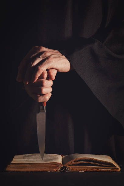 Religious man holding knife.