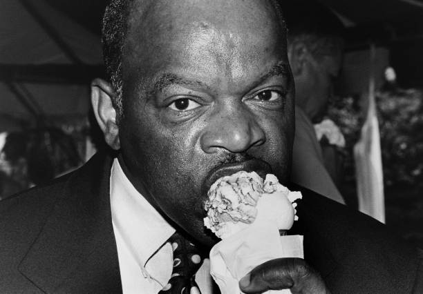 representative-john-lewis-bites-into-marble-fudge-icecream-cone-june-picture-id641482192