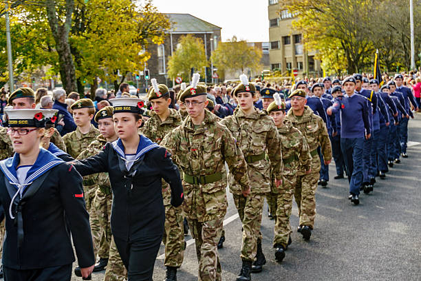 Representatives of the armed forces marching through town