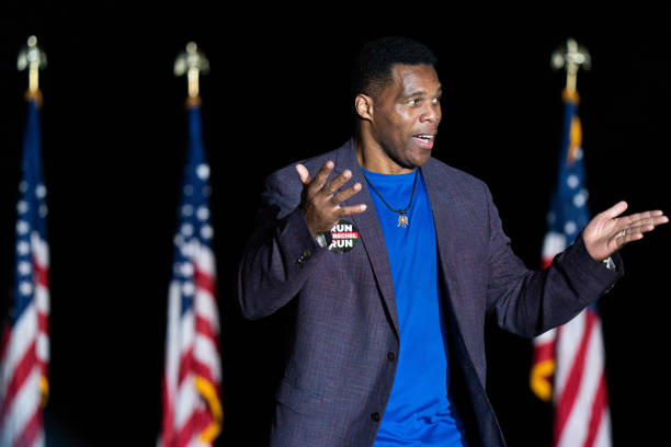 Republican Senate candidate Herschel Walker greets the crowd during a rally with former President Donald Trump on September 25, 2021 in Perry,...