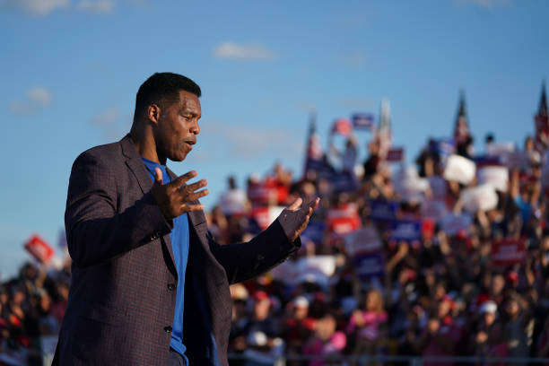Republican Senate candidate Herschel Walker walks off the stage during a rally featuring former US President Donald Trump on September 25, 2021 in...