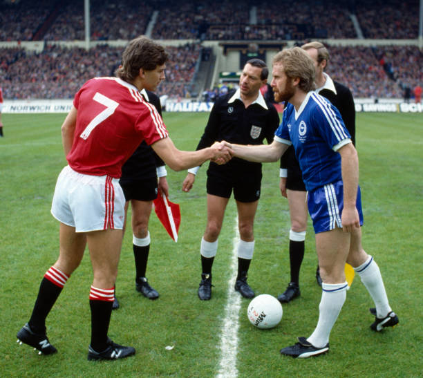 Rival captains Bryan Robson of Manchester United and Tony Grealish of Brighton shake hands before the FA Cup Final between Brighton and Manchester...