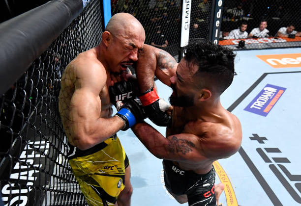 Rob Font elbows Jose Aldo of Brazil in their bantamweight fight during the UFC Fight Night event at UFC APEX on December 04, 2021 in Las Vegas,...