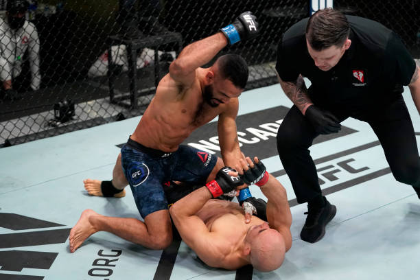 Rob Font punches Marlon Moraes of Brazil in a bantamweight fight during the UFC Fight Night event at UFC APEX on December 19, 2020 in Las Vegas,...